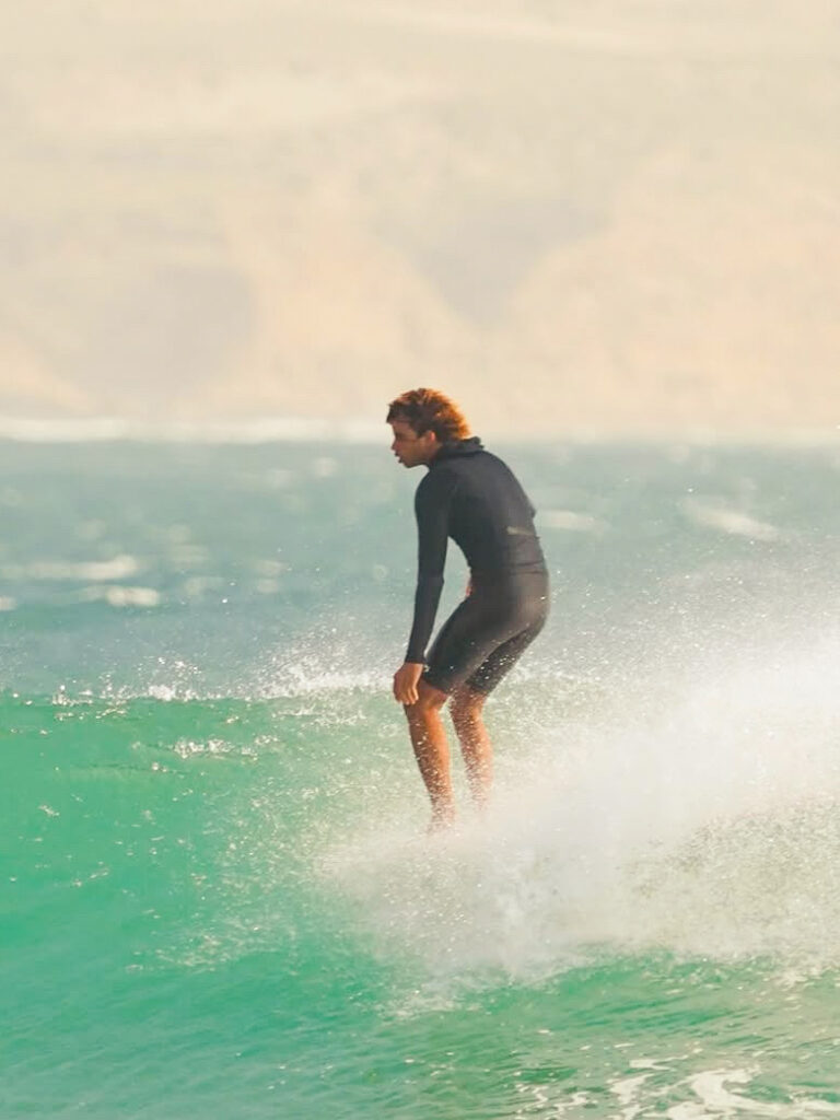 Moroccan surfer noseriding a longboard in Imsouane's waves.